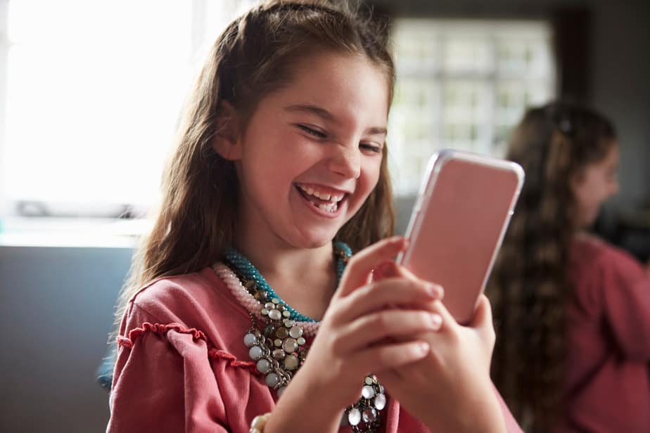 Girl Playing Dressing Up Game Taking Selfie On Mobile Phone