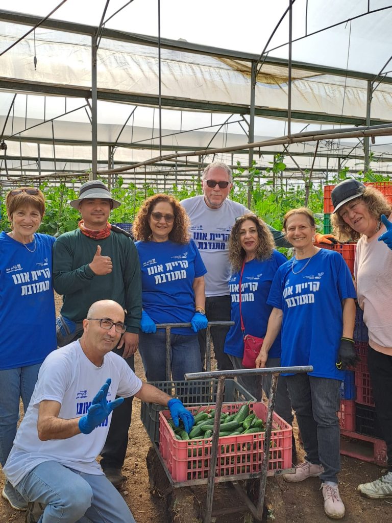 רחל רביב, מנהלת המחלקה להתנדבות בעיר (,בתמונה באמצע) יזמה במהלך המלחמה ימי קטיף לחקלאים בקווי העימות. צילום באדיבות המחלקה להתנדבות בעיריית ק אונו